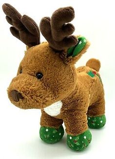 a small stuffed reindeer with green boots on