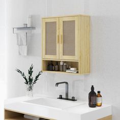 a bathroom sink with wooden cabinets above it