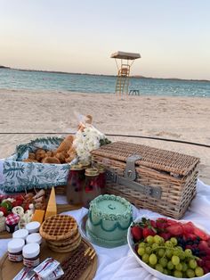 an assortment of food on a table at the beach