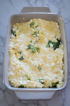 a casserole dish with broccoli and cheese