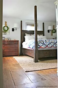 a bed room with a neatly made bed and wooden dresser next to the door way