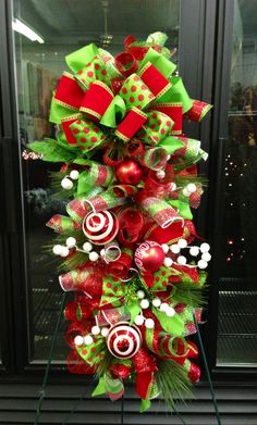 a green and red christmas wreath with candy canes