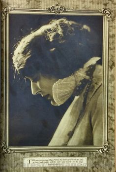 an old photo of a woman with her hair pulled back