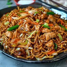 a plate full of noodles with meat and vegetables