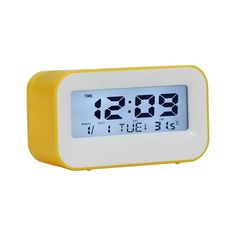 a yellow and white alarm clock with the time at 3 55 pm on it's display