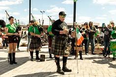 a group of people in kilts playing bagpipes