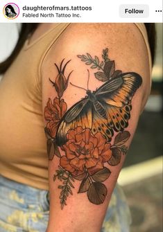 a woman with a butterfly and flowers tattoo on her arm