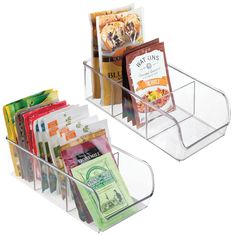 two clear bins with food and snacks in them on a white background for display