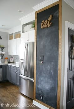 a chalkboard door in the middle of a kitchen