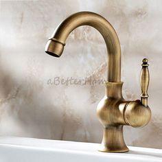 an antique brass faucet on a white bathtub