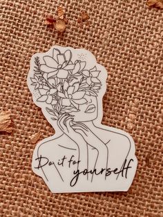 a sticker that says, don't be yourself with flowers in the middle