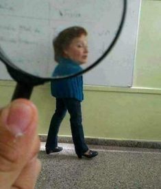 a person holding a magnifying glass looking at a child's face through it