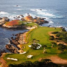 an aerial view of a golf course near the ocean