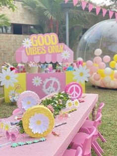 a pink table topped with lots of flowers