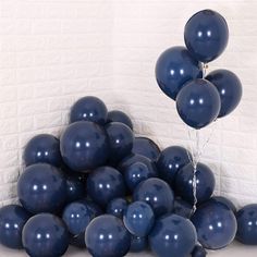 a bunch of blue balloons floating in the air