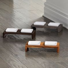 three wooden benches sitting on top of a hard wood floor