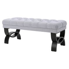 a gray bench with black legs and a buttoned up seat on the backrest