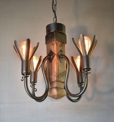 a wooden chandelier with five lights hanging from it