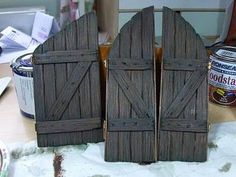 two wooden doors sitting on top of a table