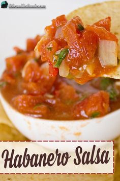 a tortilla chip being held up with salsa in it and the words habanero salsa on top