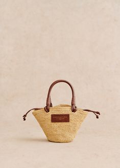 Made in our atelier in Madagascar;Basket carried on the shoulder;Hand-woven raffia exterior;Handle not adjustable;Carried on the shoulder and in the hand;Closes with leather ties;Cotton lining;Length of handles: 10 cm / 46 cm / 3.9 in / 18.1 in;Weight of the bag: 0,4 kg / 14.1 oz;Dimensions: 15 x 31 x 10 cm / 5.9 x 12.2 x 3.9 in Ochre Flowers, Raffia Embroidery, Lifestyle Dresses, Mini Basket, Raffia Bag, Woven Raffia, Basket Bag, Best Bags, Spring 2024