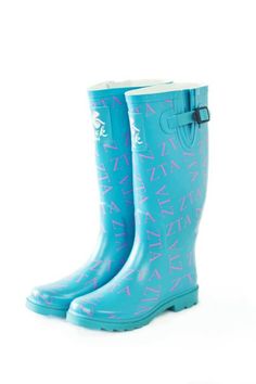 a pair of blue rain boots with pink letters on them