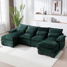 a green sectional sofa sitting on top of a white rug