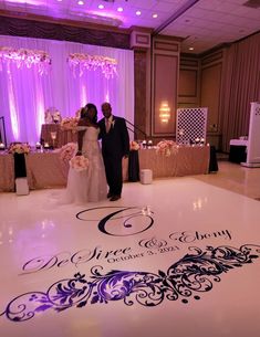 a bride and groom standing on the dance floor at their wedding reception in an elegant ballroom