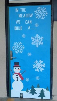 a door decorated with snowmen and words in the meadow, we can build a snowman