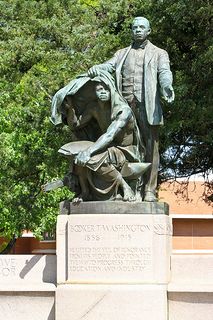 a statue of a man with a hat and coat