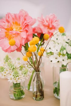 three vases filled with different types of flowers