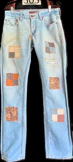 an old pair of jeans with patches on them