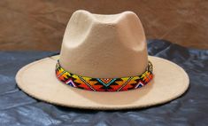 100 % Leather Hat-band is Hand Beaded with intricate beaded patterns by skilled Artisans Inspired by Native American crafting techniques and Indian beaded jewelry Beaded portion about 19.0 inches, handmade products, dimensions may slightly vary. Adjustable ties in the back. Hypoallergenic - Made with non-reactive Materials 100 percent Natural Environment friendly materials. Handcrafted with tiny Cubic Zirconia Seed Beads with beautiful and detailed beadwork. Handmade Southwestern Multicolor Hats, Handmade Multicolor Southwestern Hats, Traditional Multicolor Beaded Hat Band, Handmade Southwestern Multicolor Hat Band, Multicolor Beaded Hats For Rodeo, Festival Multicolor Beaded Hats, Multicolor Beaded Hat Band For Rodeo, Beaded Brown Hat Band For Festival, Beaded Brown Hat Bands For Festival