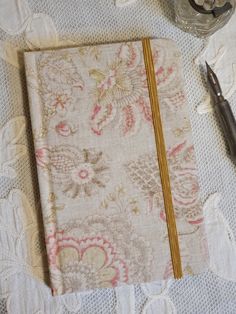 Pocket Notebook covered in charming paisley fabric - Ruled Pages You will enjoy filling the smooth and fountain pen friendly pages of our beautiful pocket notebooks.  Covered in a selection of gorgeous French and vintage fabrics, they are expertly hand-bound in the UK with great attention to detail. Each one is unique and would make a wonderful gift for pen and paper lovers.  This pocket notebook is covered in a delightful paisley fabric in delicate colours. Finished with ribbon page marker and matching elastic closure, it is perfect for those who prefer writing on ruled paper, and will fit nicely inside a handbag. An address book in the same fabric is available separately (shown on the last photograph). 160 pages of 100gsm top quality ivory ruled paper  9.5 x 14.5 cm approx. As is to be e Vintage Floral Fabric, Ruled Paper, Paisley Fabric, Paper Lovers, Pocket Notebook, Design Rules, Page Marker, Fabric Birds, Notebook Cover