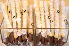 corn on the cob and other food items displayed in a glass container with gold trim