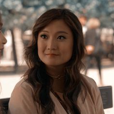 two women sitting next to each other on a bench