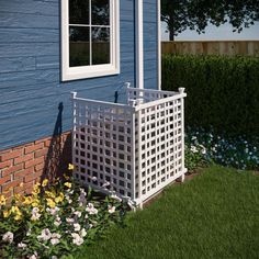 a white trellis planter in front of a blue house