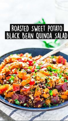 roasted sweet potato black bean quinoa salad in a blue bowl with a spoon