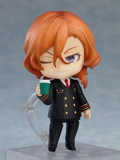 an anime figurine is holding a coffee cup and wearing a black suit with gold buttons