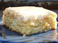 a piece of cake sitting on top of a blue and white plate with frosting