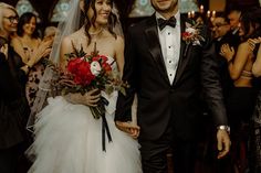 a bride and groom walking down the aisle