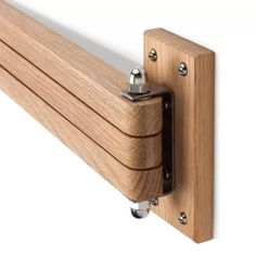 a close up of a wooden object on a white wall with metal hardware and wood planks