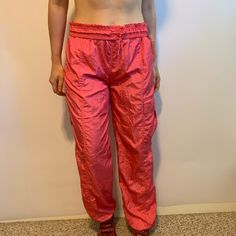 New With Tags, Women’s Size Medium Coral Pink Adidas Track Pants. Adjustable Tie Waist With A Pocket On The Side. 31 Inch Inseam, And Elastic Around The Ankles. Casual Adidas Sports Bottoms, Adidas Relaxed Fit Casual Sweatpants, Sporty Adidas Spring Bottoms, Adidas Casual Sports Bottoms, Sporty Adidas Bottoms For Spring, Casual Pink Parachute Pants For Loungewear, Adidas Sports Nylon Pants, Adidas Nylon Sports Pants, Casual Adidas Nylon Pants