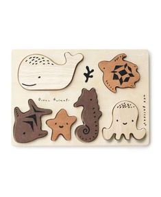 a wooden puzzle with different types of sea animals on the front and back of it