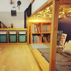 there is a bunk bed with bookshelves in the room