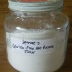 a jar filled with flour sitting on top of a wooden table