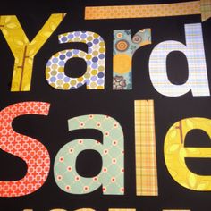 yard sale sign with the words yard sale written in large, colorful letters on a black background