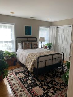 a bed sitting on top of a rug in a bedroom