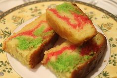 three pieces of cake sitting on top of a white and yellow plate next to each other