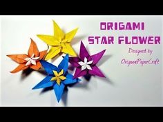 three origami star flowers sitting on top of each other in different colors and sizes